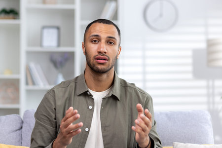 Close-up photo of a young African-American man seriously talking and talking to the camera while...