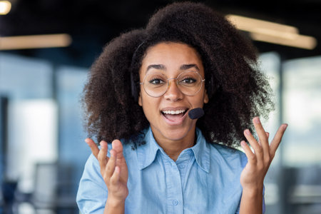 Call center worker talks and advises consumer buyers online, woman smiles joyfully and looks at...