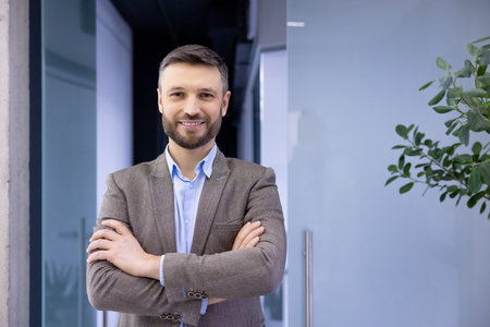 Portrait of mature successful businessman in business suit inside office, experienced satisfied man...