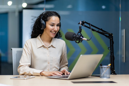 Woman hosting podcast speaking into microphone while wearing headphones. Confident professional...