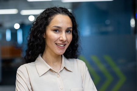 Portrait of confident businesswoman smiling in office environment. Strong professional woman with...