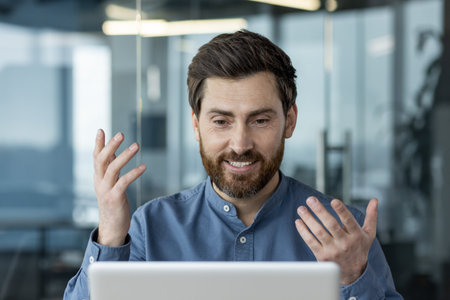 Confident businessman engaged in virtual meeting communicates via laptop. Professional discussing...