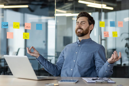 Businessman practicing mindfulness meditation in modern office surrounded by colorful sticky notes...
