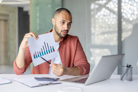 A professional individual presenting graph data while engaged in an online meeting at work. Captures themes of communication, analysis, and productivity in a contemporary office setting.の写真素材