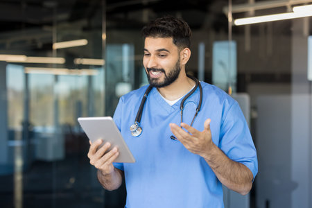 Young male doctor wearing scrubs and a stethoscope, engaging in a virtual medical consultation with...