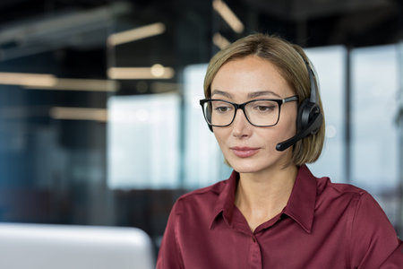 Woman wearing a professional headset with a microphone, focusing on her work, representing concepts...