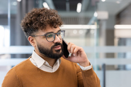 Man talking on his smartphone, communicating important information during a business call in a...
