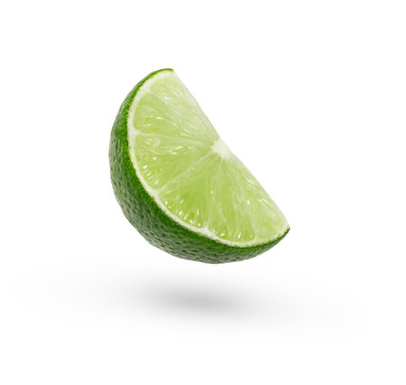 A slice of lime floating in the air isolatedの写真素材
