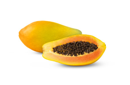 Whole yellow or orange papaya fruit with cut in half isolated.の写真素材