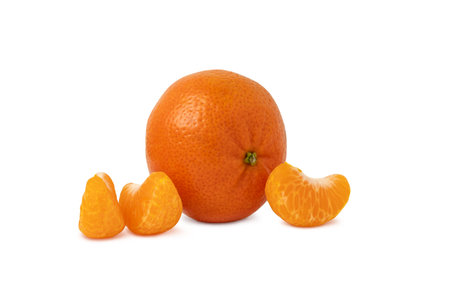 The whole tangerine and slices of peeled tangerine, mandarin or clementine isolatedの写真素材