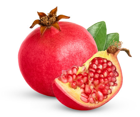 Ripe pink pomegranate with cut in chunk and green leaf isolated with clipping path.の写真素材