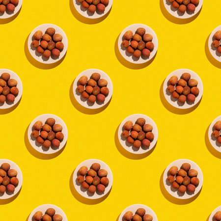 Lychee fruit on bright yellow background, lychee on the plate pattern.の写真素材