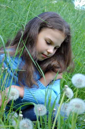 beautiful young girl relaxing in the grassの写真素材