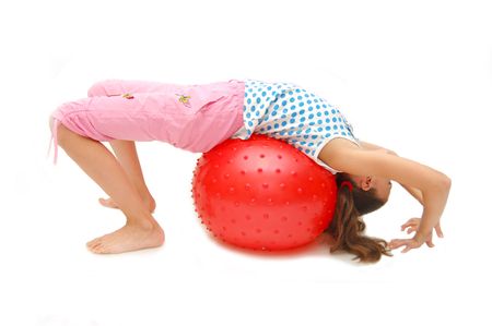 beautiful young girl with ball exercisingの写真素材