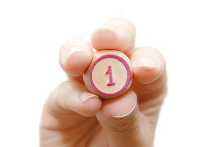 The female hand holds Keg number one on a white background
