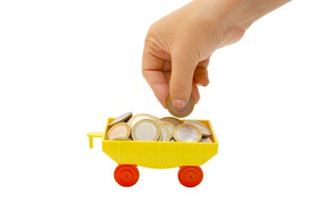Toy train carrying coins on a white backgroundの写真素材