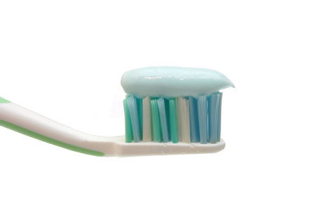 Close-up of a toothbrush with paste isolated on white background

