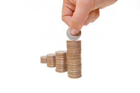 Increase your savings-Hand holding coins against white backgroundの写真素材