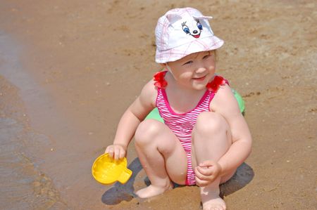 nice little girl on a river beachの写真素材