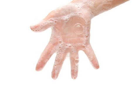 Female hand in soapsuds isolated on whiteの写真素材