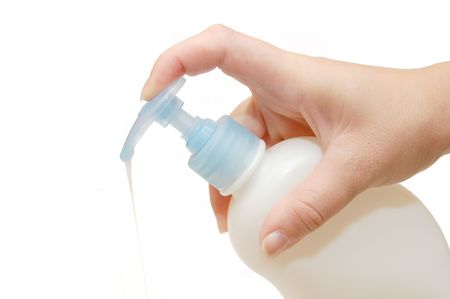 object on white - Bottle of liquid soap in female handの写真素材