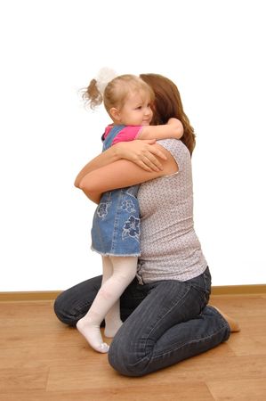 Mother and her little daughter on wooden  floorの写真素材