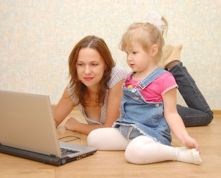 Mother and Daughter Using Laptop on wooden  floor
の写真素材