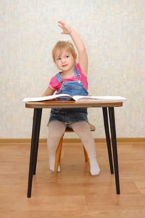 Small cute  girl with hand up の写真素材