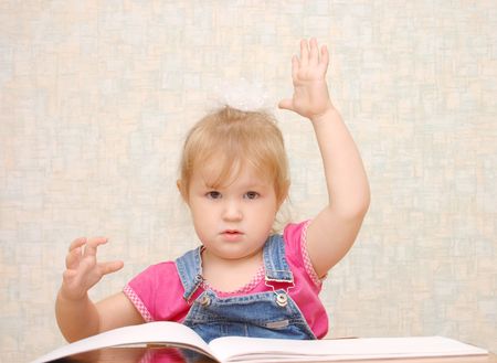 Small cute  girl with hand up の写真素材
