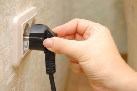 female hand sticks a plug in the socket
の写真素材