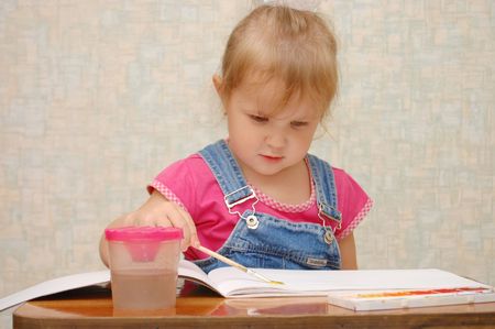 Small cute painting girl at homeの写真素材