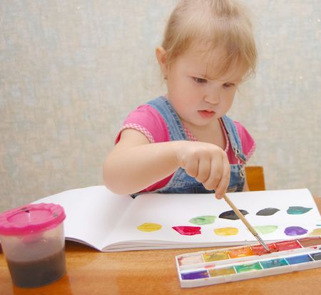 Small cute painting girl at homeの写真素材