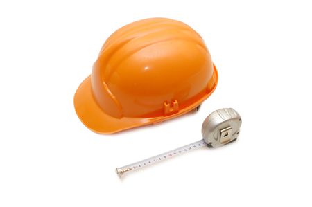 Orange helmet and measuring tape isolated on white backgroundの写真素材