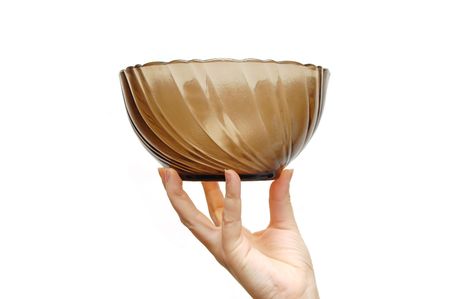 Empty glass dish in a female hand, isolated on white backgroundの写真素材