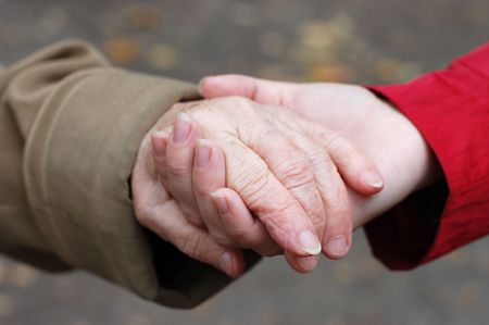 closeup of a grandfather holding his grand daughter hand
の写真素材