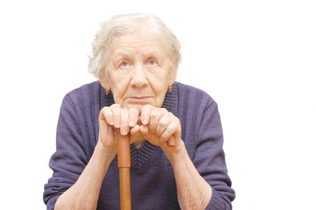 Grandmother holding a cane on white backgroundの写真素材