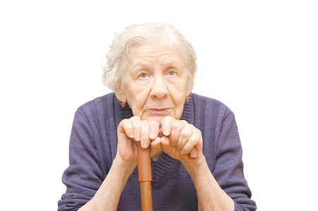 Grandmother holding a cane on white backgroundの写真素材