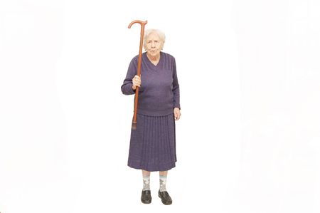 Grandmother holding a cane on white backgroundの写真素材