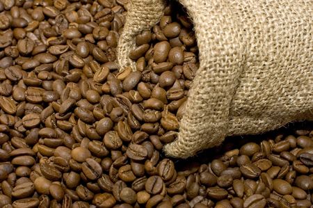 Linen bag with fragrant coffee on beansの写真素材
