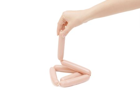 Fresh sausages in a hand isolated の写真素材