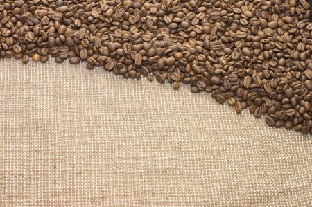 Brown coffee grains on a sacking
の写真素材