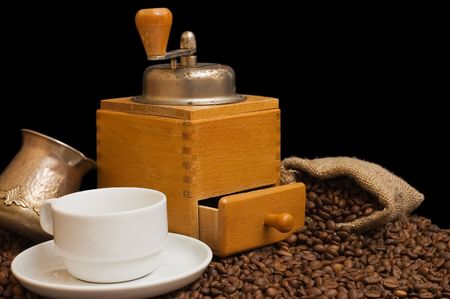 Old coffee grinder isolated on black backgroundの写真素材