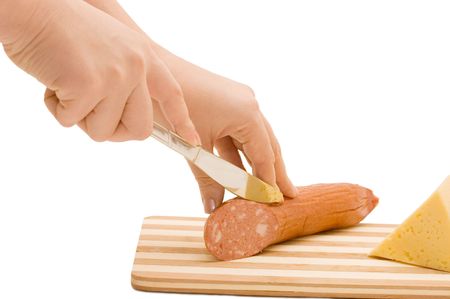 The hand with a knife cuts sausageの写真素材