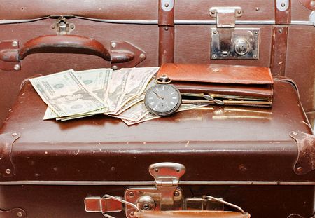 Money lays on an old suitcaseの写真素材