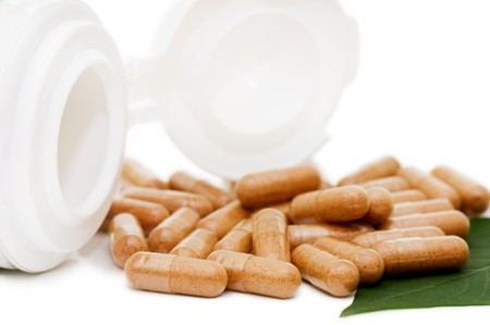 Pills with green sheet isolated on whiteの写真素材