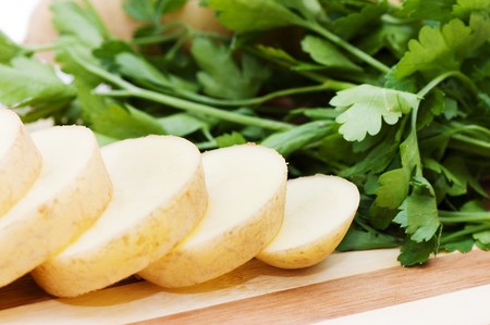 The cut potato on a chopping board の写真素材