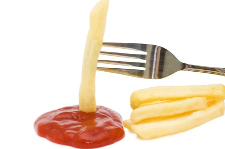 Fried chipped potato on a fork の写真素材