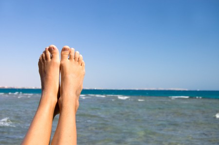 Female feet against the seaの写真素材