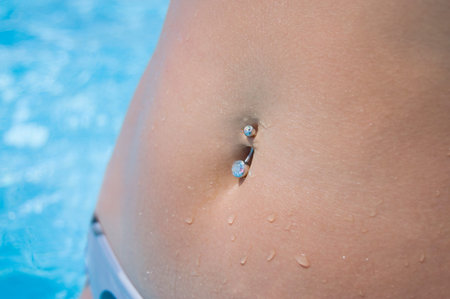 Piercing in a stomach at the girl