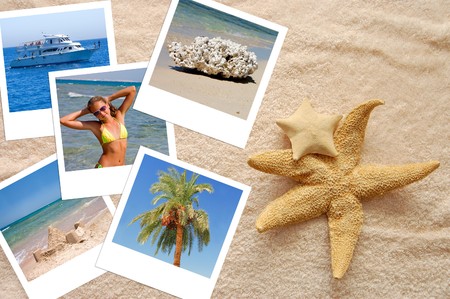 Two starfishes and photos on a beach towelの写真素材